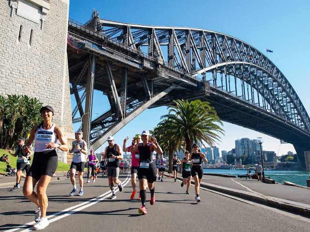 Runners racing beneath Sydney Harbour Bridge